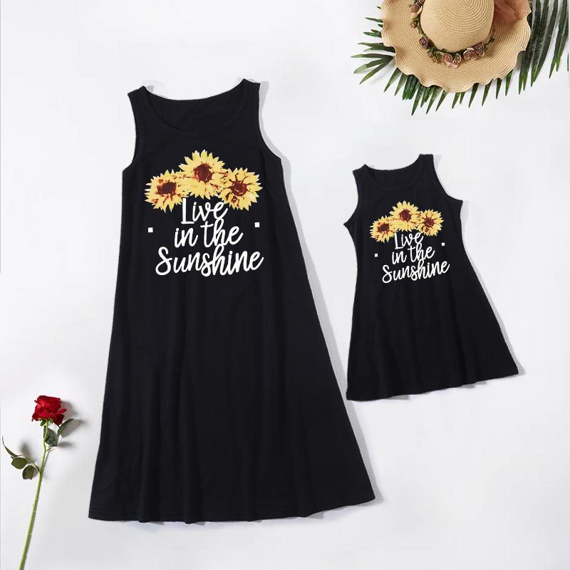 black dress, sunflowers, live in the sunshine text displayed